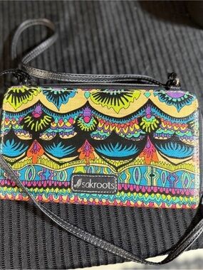 This colorful item is a Sakroots Artist Circle Smartphone Crossbody bag.